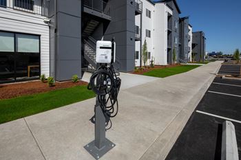 A parking lot with a charging station for electric vehicles.